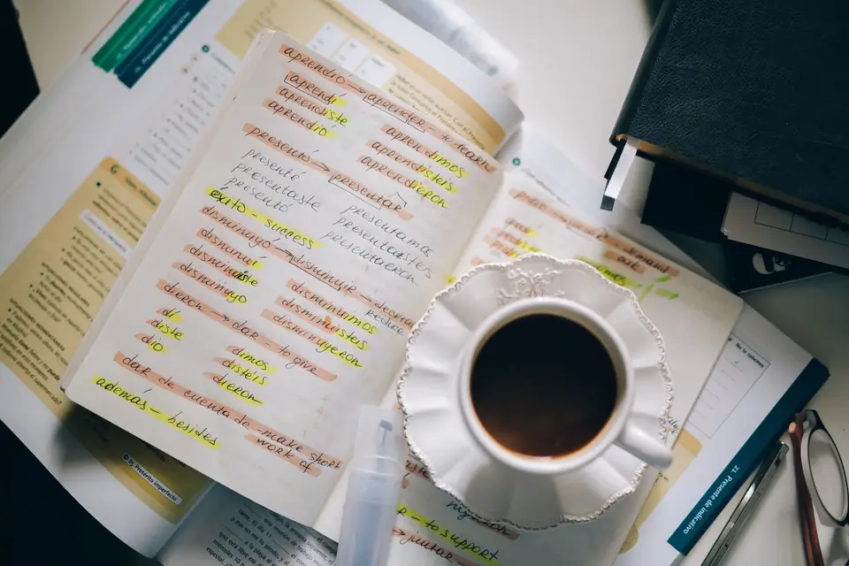 Highlighted study notes beside a cup of coffee